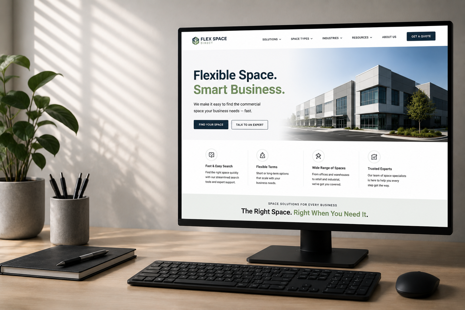 Modern responsive commercial real estate website displayed on a desktop monitor in a clean office workspace.